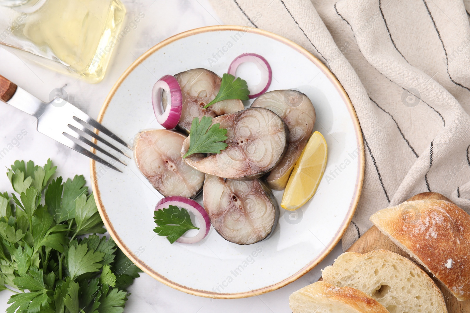 Photo of Slices of tasty salted mackerel served on white table, flat lay