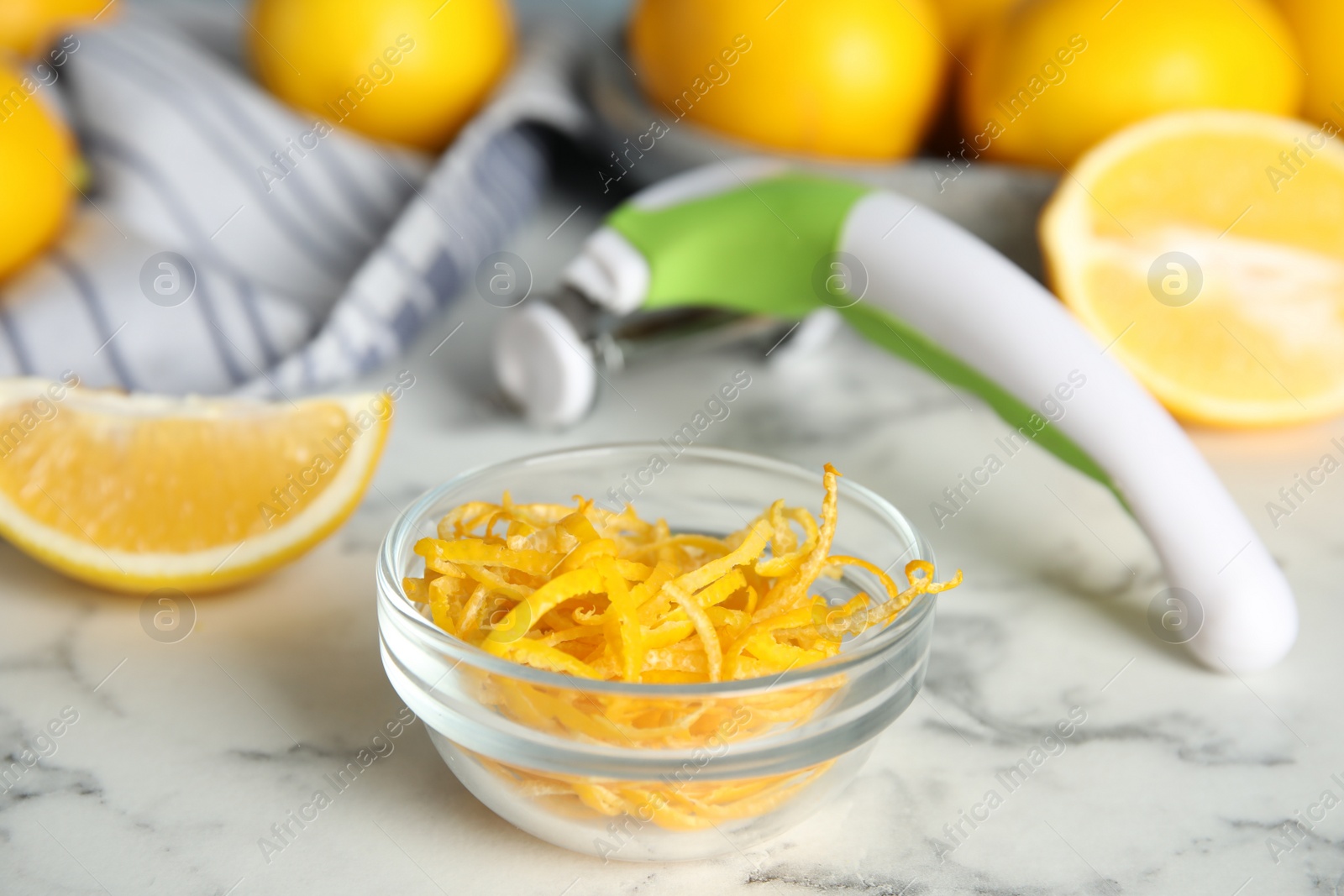 Photo of Lemon zest and fresh fruits on white marble table