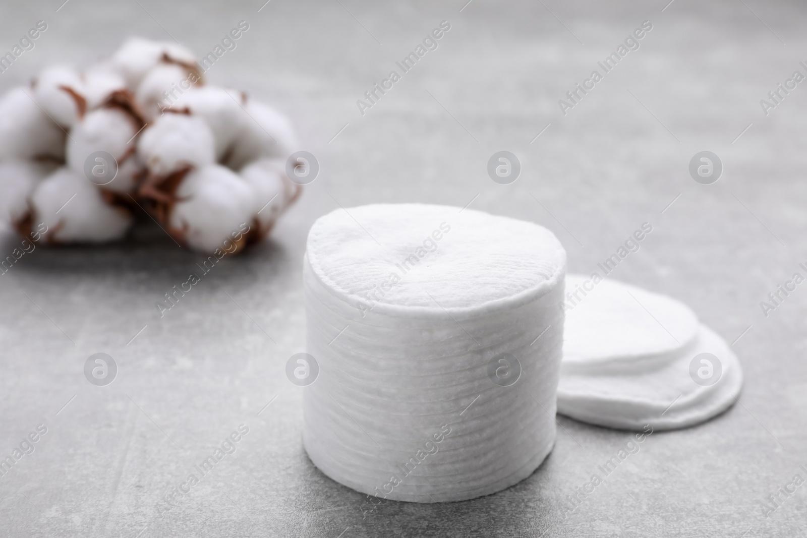 Photo of Stack of clean cotton pads on light grey table