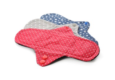 Photo of Many cloth menstrual pads on white background. Reusable female hygiene product