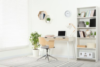 Photo of Beautiful workplace with comfortable desk and chair at home