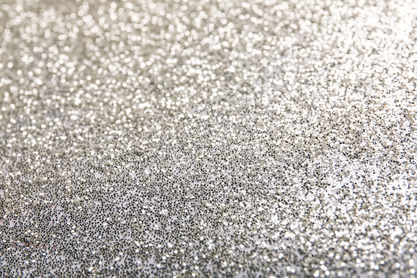 Photo of Closeup view of sparkling silver glitter background