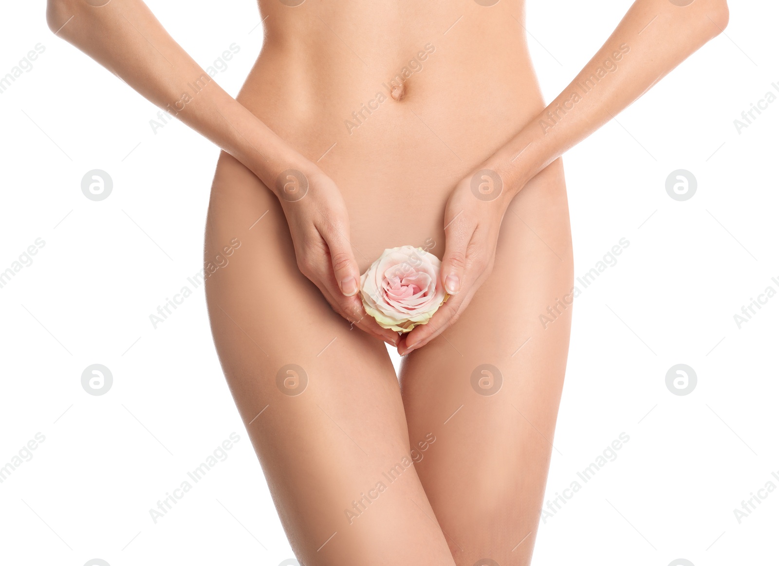 Photo of Woman with flower showing smooth skin after Brazilian bikini epilation on white background, closeup. Body care concept