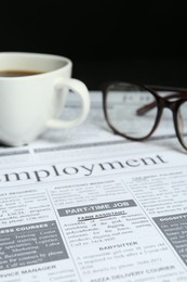 Photo of Cup of coffee and glasses on newspaper. Search concept