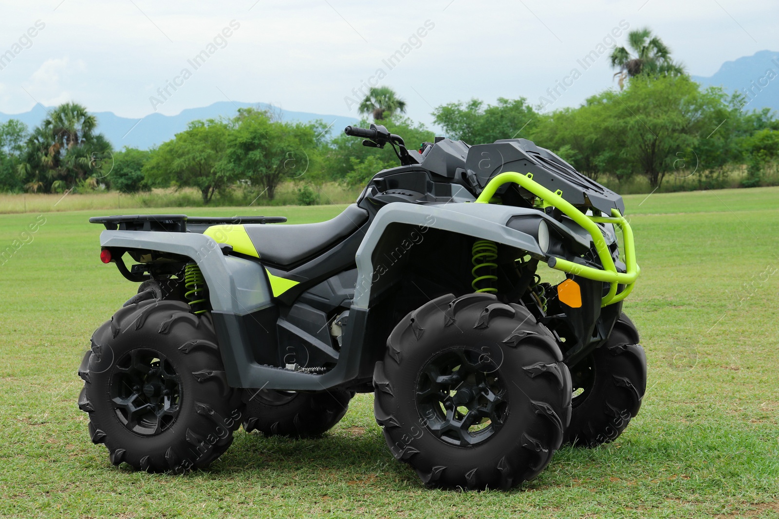 Photo of Modern quad bike on green grass outdoors