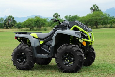 Modern quad bike on green grass outdoors