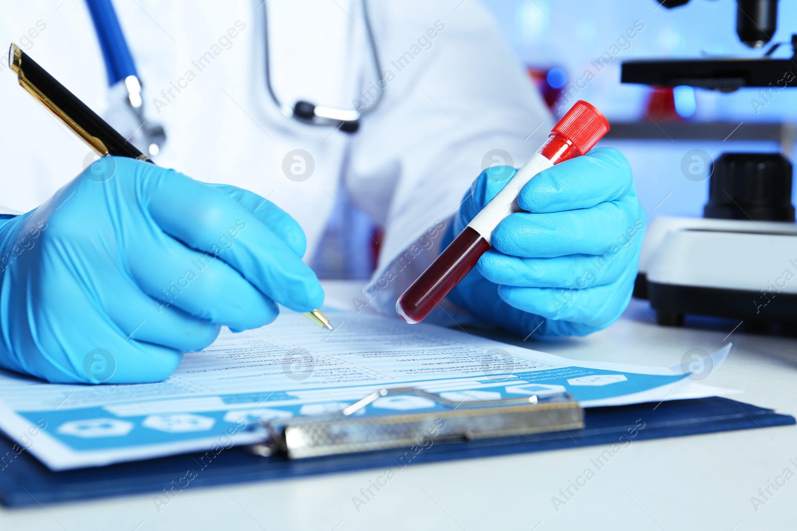 Photo of Scientist working at table in laboratory, closeup. Research and analysis