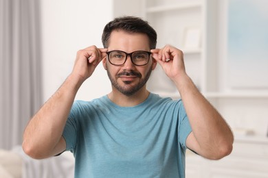 Portrait of man in stylish glasses at home