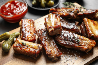 Delicious grilled ribs served on table, closeup