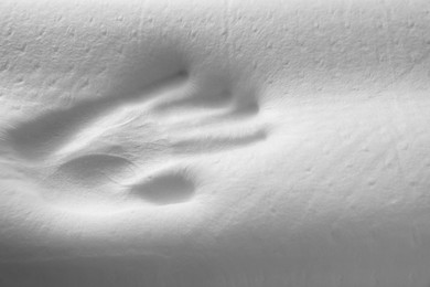 Photo of Handprint on white memory foam pillow, closeup