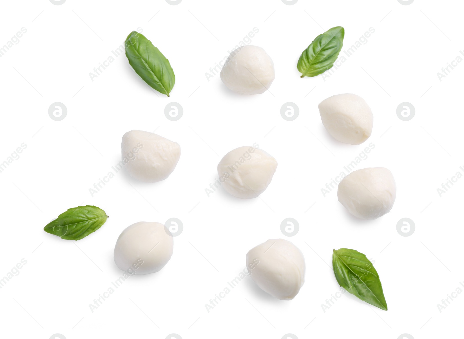 Photo of Tasty mozzarella balls and basil leaves isolated on white, top view
