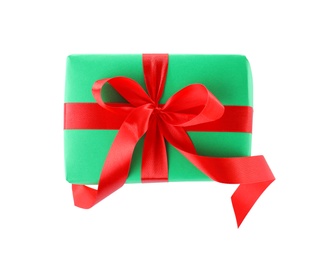 Photo of Christmas gift box decorated with ribbon bow on white background, top view