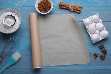 Photo of Baking parchment paper, kitchen tools and different ingredients on light blue wooden table, flat lay. Space for text