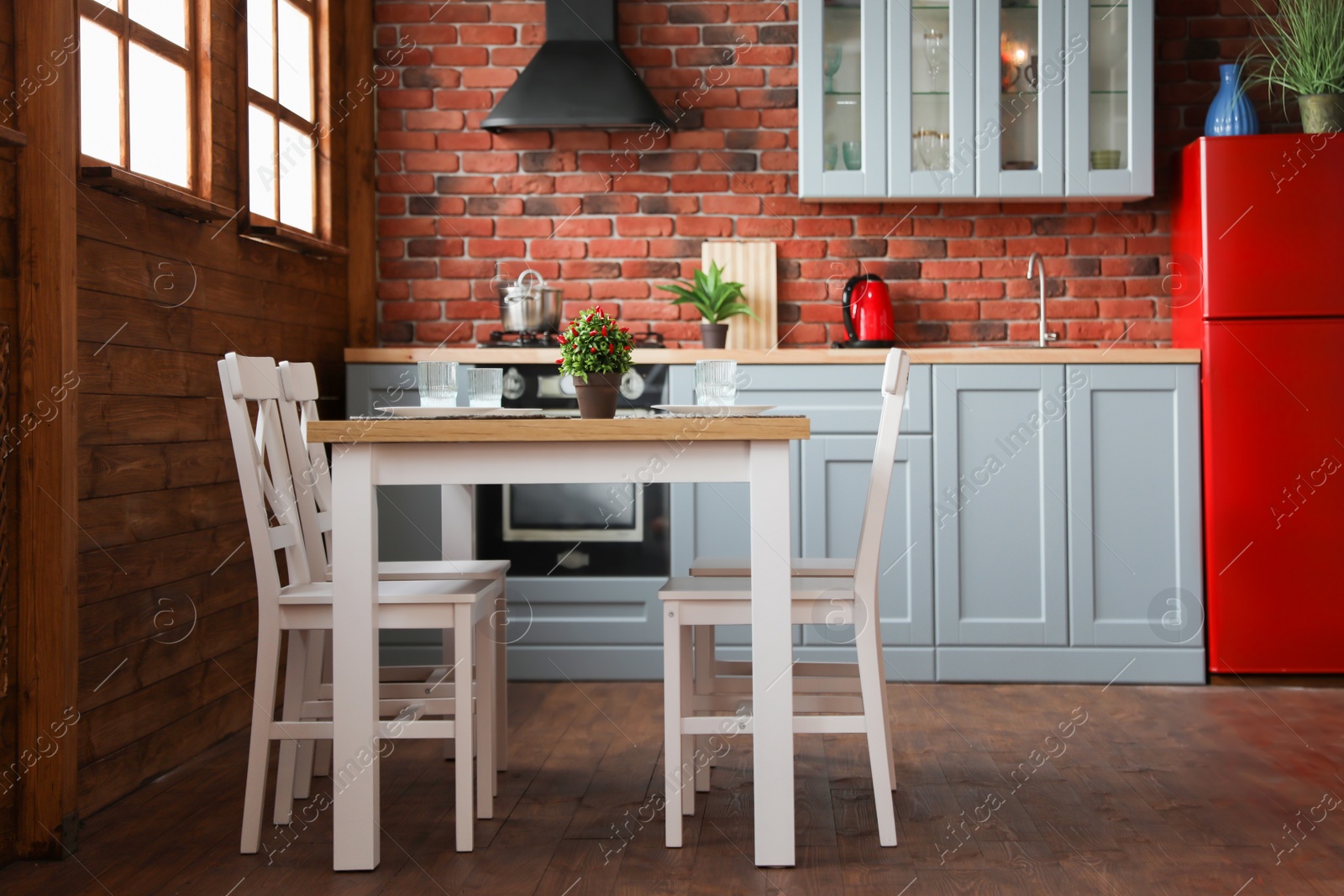 Photo of Stylish kitchen interior with dining table and chairs