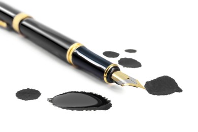 Stylish black fountain pen and blots of ink isolated on white