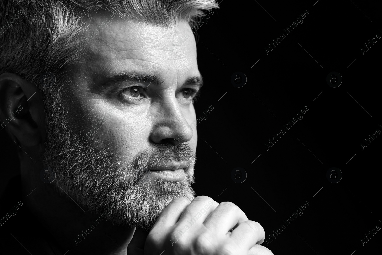 Photo of Portrait of handsome man on dark background, space for text. Black and white effect