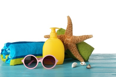 Set of different beach accessories on table against white background. Space for text