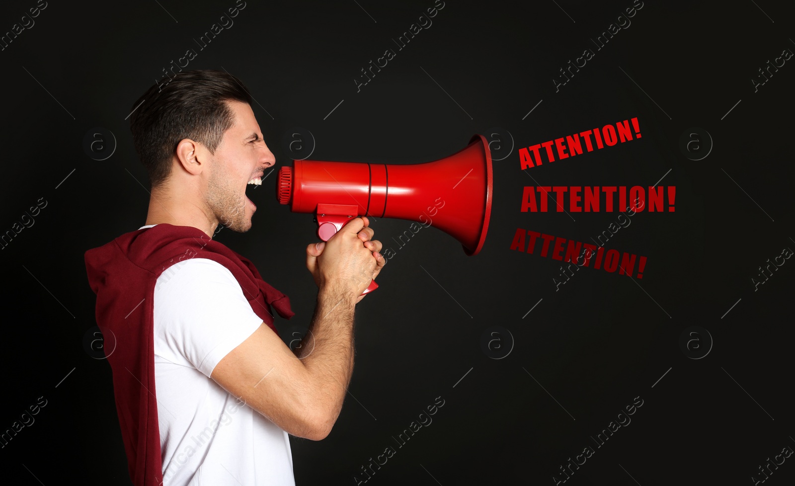 Image of Handsome man with megaphone on black background