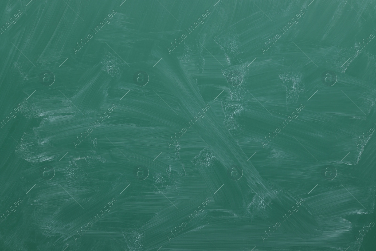 Photo of Dirty green chalkboard as background. School equipment