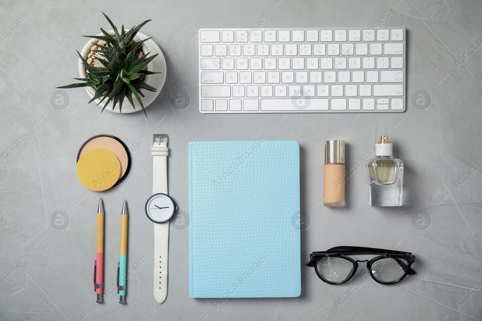 Photo of Flat lay composition with computer keyboard, cosmetics and blank notebook on light background, space for text. Blogger's workplace