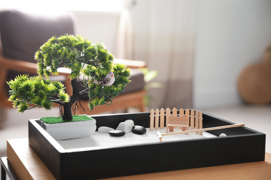 Photo of Beautiful miniature zen garden on wooden table indoors