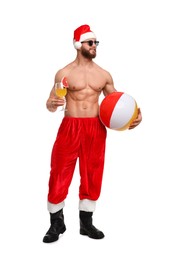 Photo of Muscular young man in Santa hat with ball and cocktail on white background