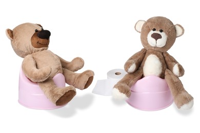 Image of Baby potties with toy bears and toilet paper isolated on white