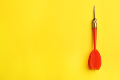 Red dart arrow on yellow background, top view with space for text