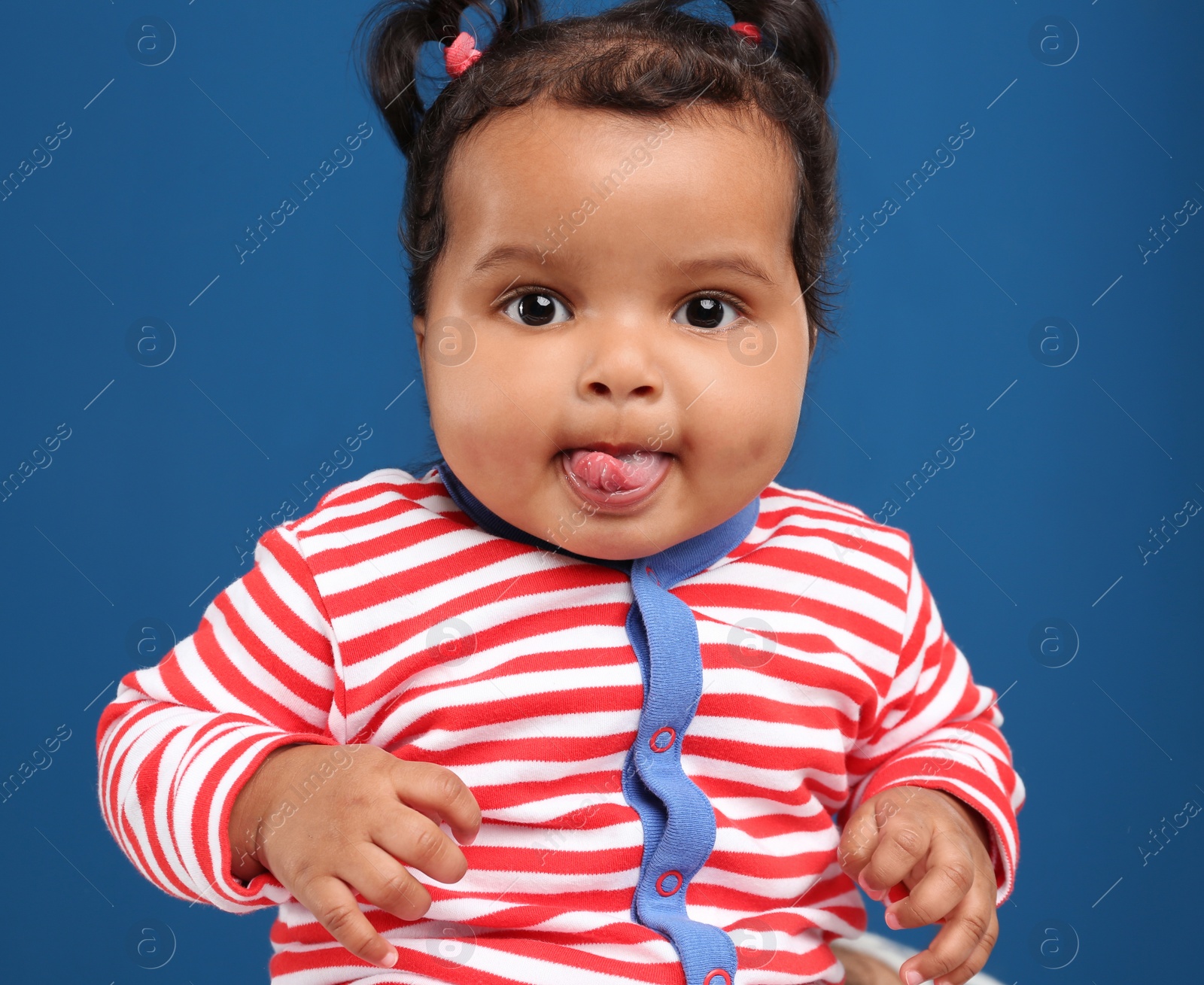 Photo of Cute African American baby on blue background