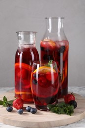 Delicious refreshing sangria and berries on table