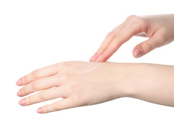 Woman applying cream on her hand against white background, closeup