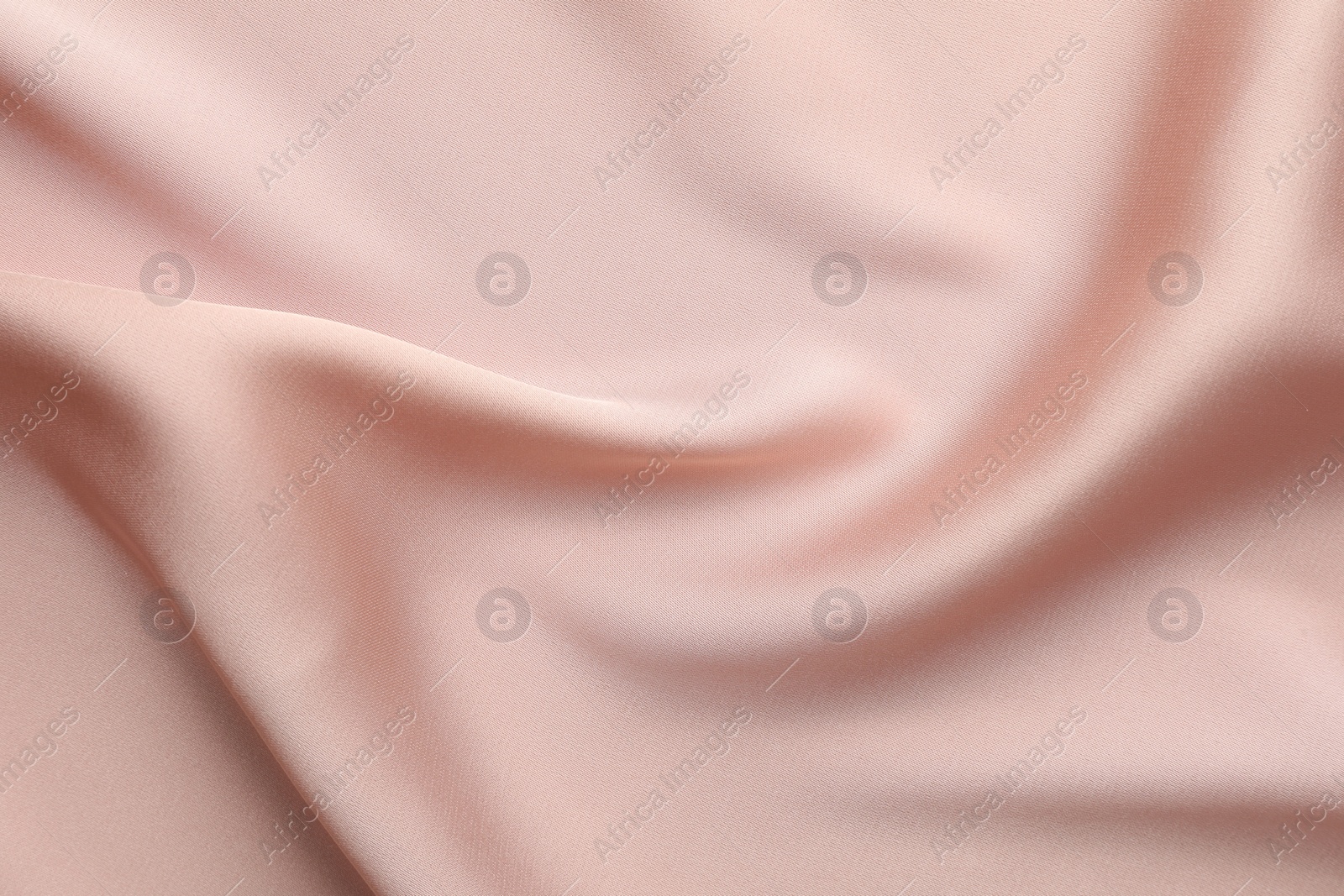 Photo of Crumpled pink silk fabric as background, top view