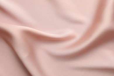 Photo of Crumpled pink silk fabric as background, top view