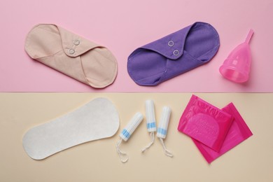 Photo of Reusable and disposable menstrual hygiene products on color background, flat lay