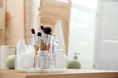 Photo of Organizer with cosmetic products and space for text on dressing table