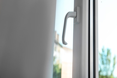 Photo of Modern window and curtain indoors, closeup view. Home interior