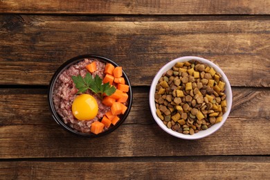 Photo of Pet food and natural ingredients on wooden table, flat lay