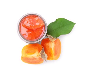 Photo of Jar of tasty persimmon jam and fresh fruits on white background, top view