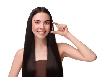 Photo of Beautiful young woman holding skincare ampoule on white background