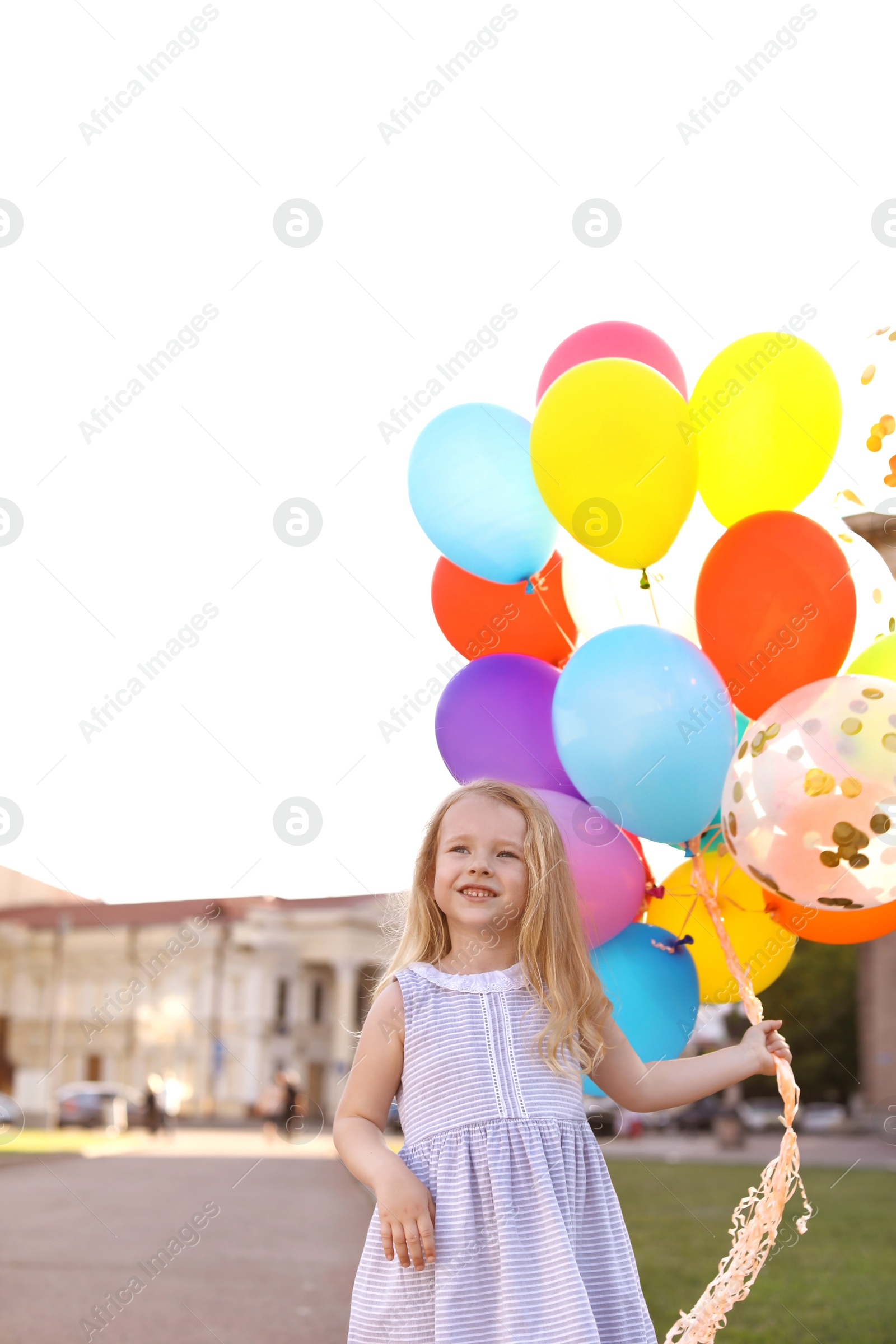 Photo of Cute little girl with colorful balloons outdoors on sunny day