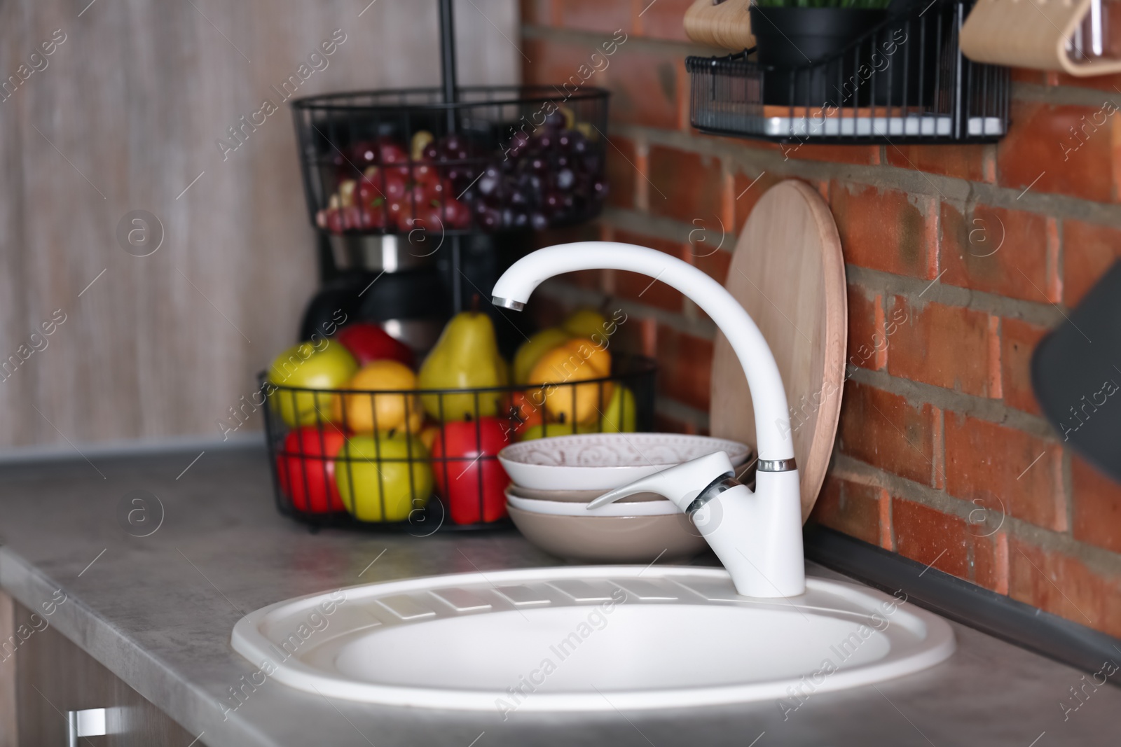 Photo of Stylish sink and faucet in modern kitchen. Idea for home design