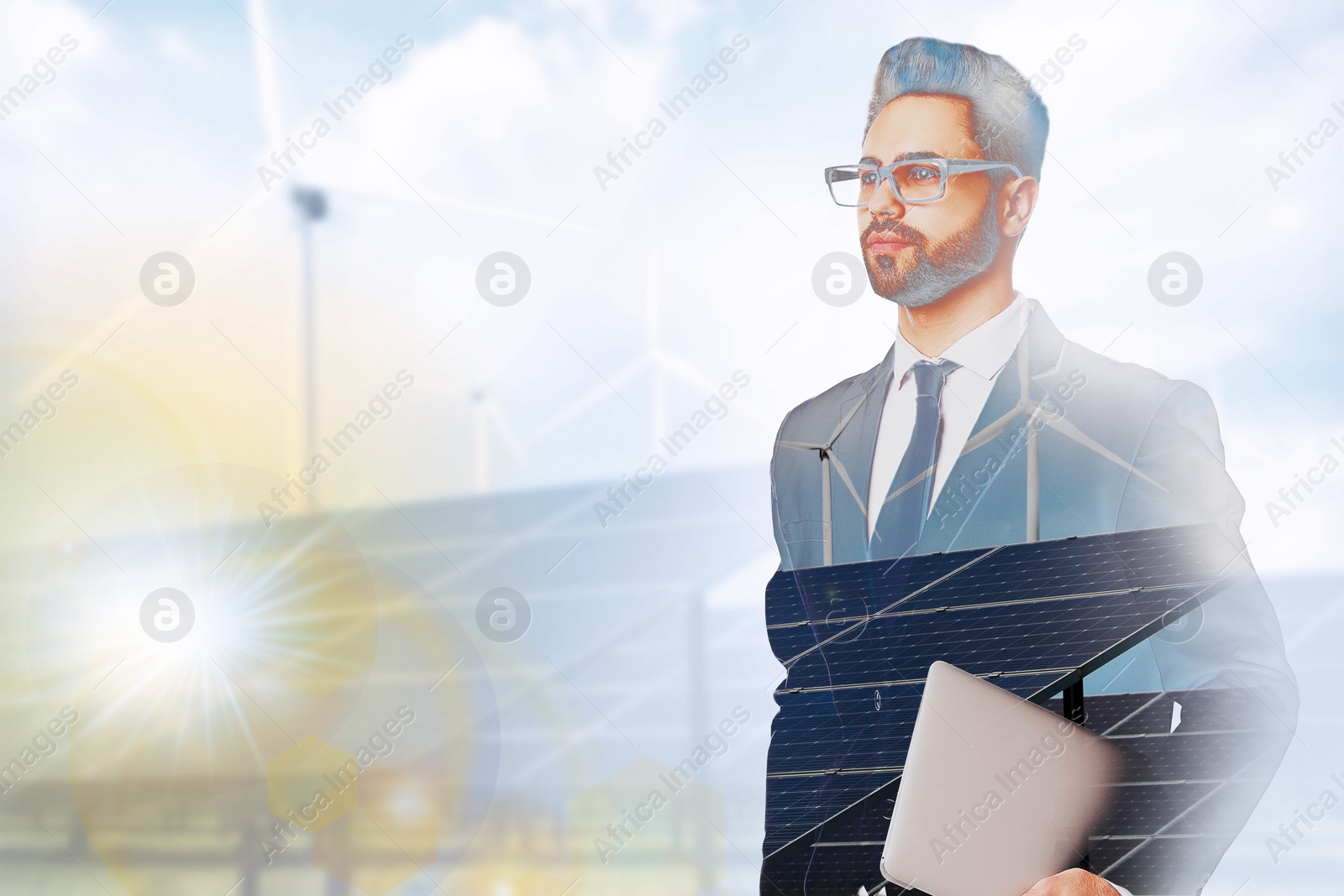 Image of Multiple exposure of businessman with laptop, wind turbines and solar panels installed outdoors. Alternative energy source
