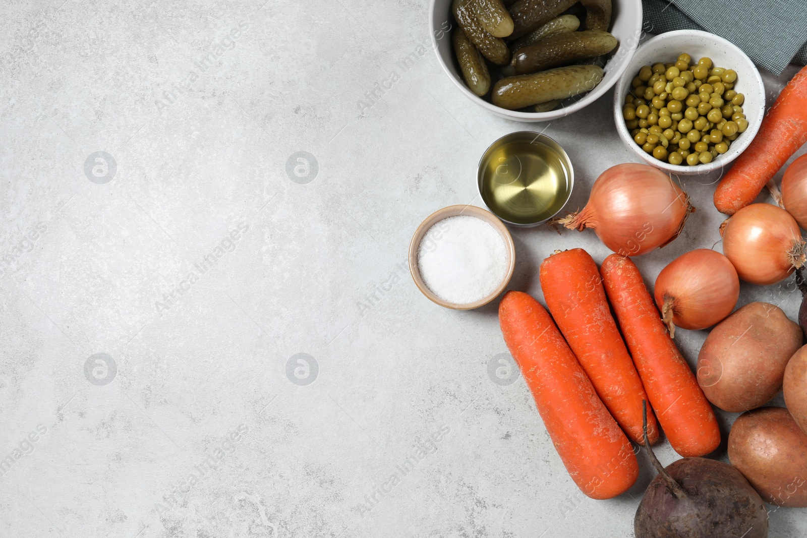 Photo of Cooking vinaigrette salad. Many fresh vegetables and other ingredients on white table, flat lay with space for text