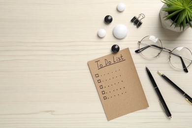 Photo of Flat lay composition with unfilled To Do list and glasses on wooden table