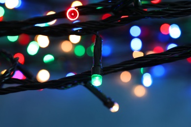 Beautiful Christmas lights on color background, closeup