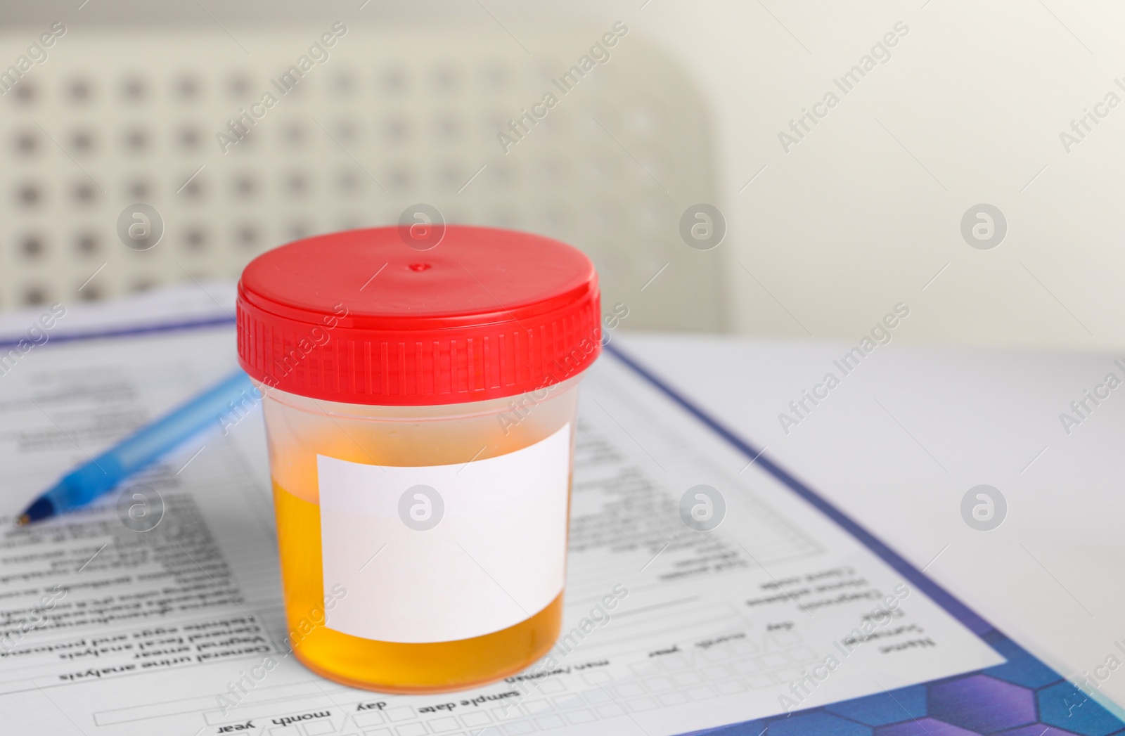 Photo of Container with urine sample on table in laboratory, space for text. Specimen collection