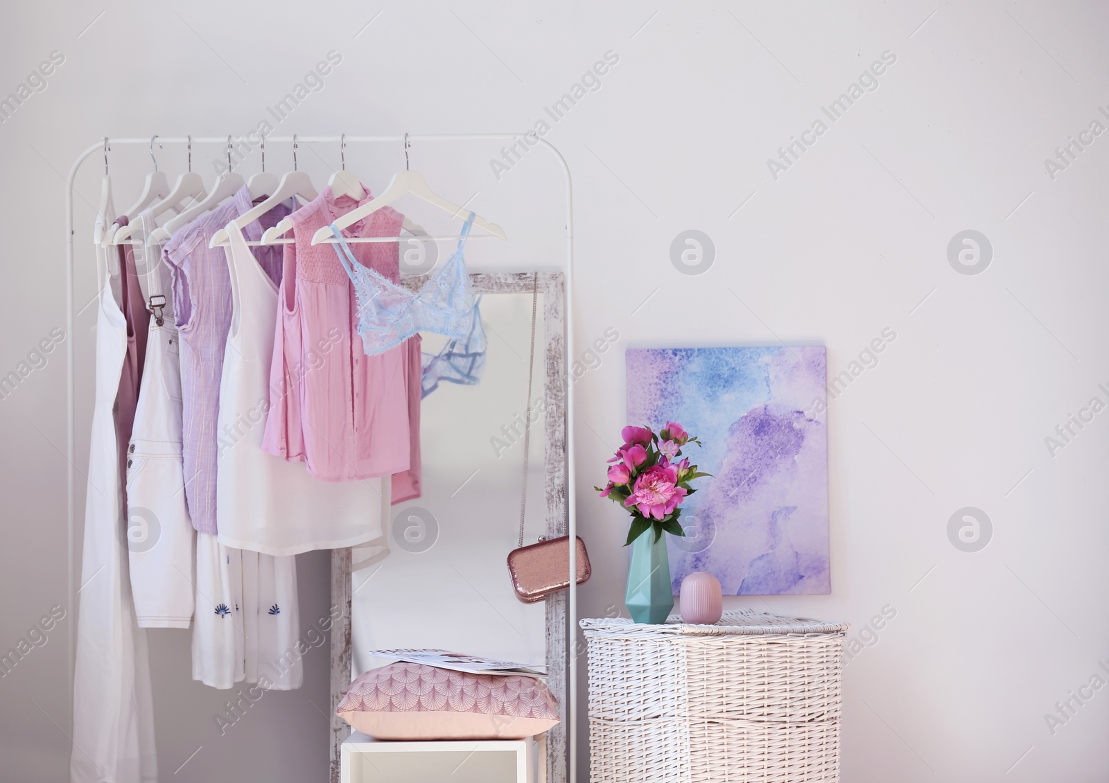 Photo of Stylish dressing room interior with clothes rack and mirror