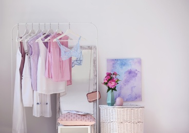 Photo of Stylish dressing room interior with clothes rack and mirror