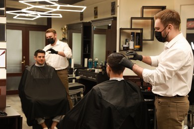 Photo of Professional hairdresser making stylish haircut in salon