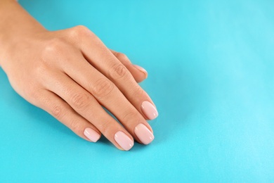 Photo of Beautiful female hand on color background, closeup with space for text. Spa treatment